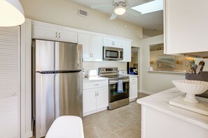 A modern kitchen with stainless steel appliances, white cabinetry, and a central island. - Private Pool! Family Escape, 11 Mi to Jensen Beach (Port St. Lucie)