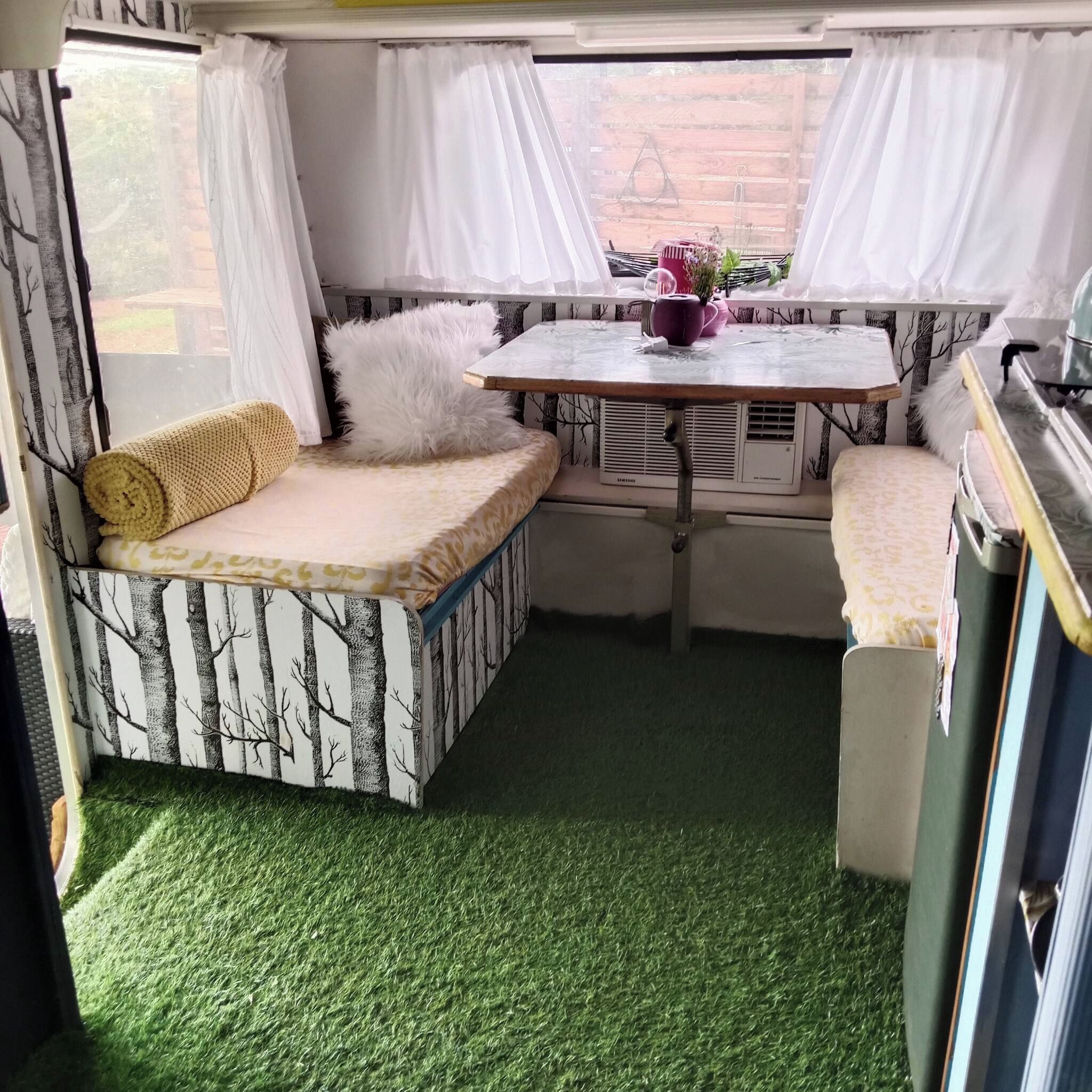 A compact room with a sofa, a small table, and a bench.