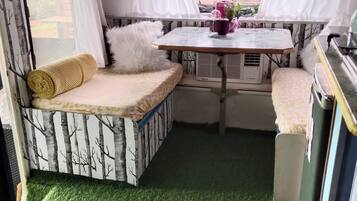 A compact room with a sofa, a small table, and a bench.