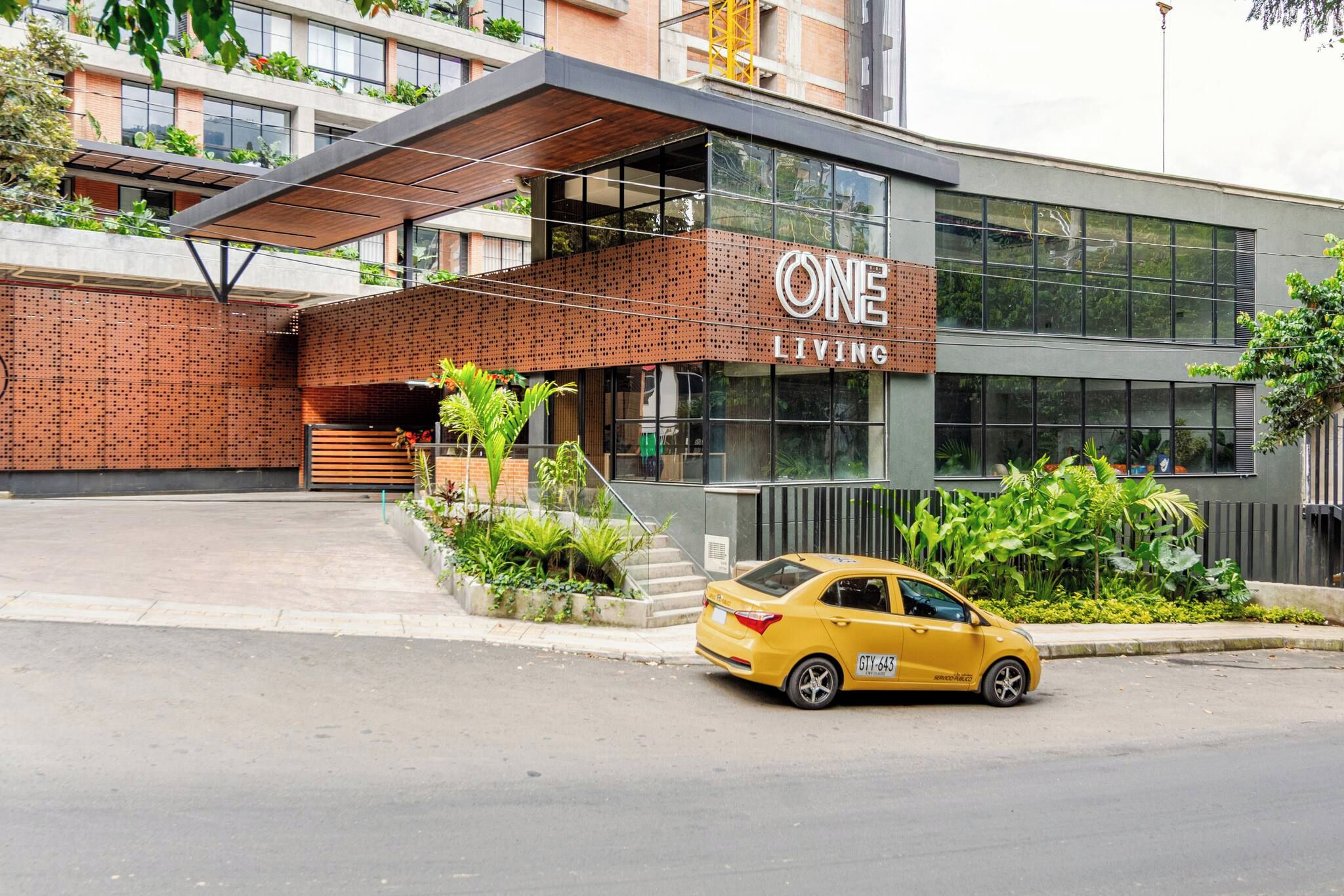 A modern building with a sign reading 'ONE LIVING'.