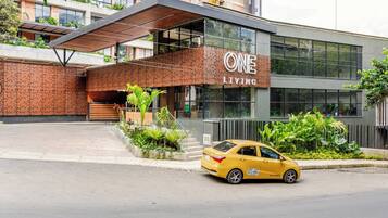 A modern building with a sign reading 'ONE LIVING'.
