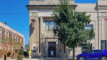 A building with a classical architectural style, featuring a prominent entrance with a door and windows.