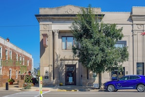A building with a classical architectural style, featuring a prominent entrance with a door and windows.