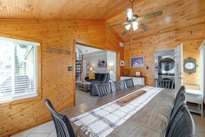 A wooden interior with a dining area, a kitchen, and a staircase. - Lake Breeze Bungalow: 3 Mi to State Park! (Clermont)