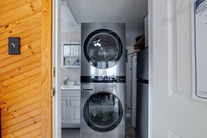 A laundry room with two large, stainless steel front-loading washers and dryers. - Lake Breeze Bungalow: 3 Mi to State Park! (Clermont)