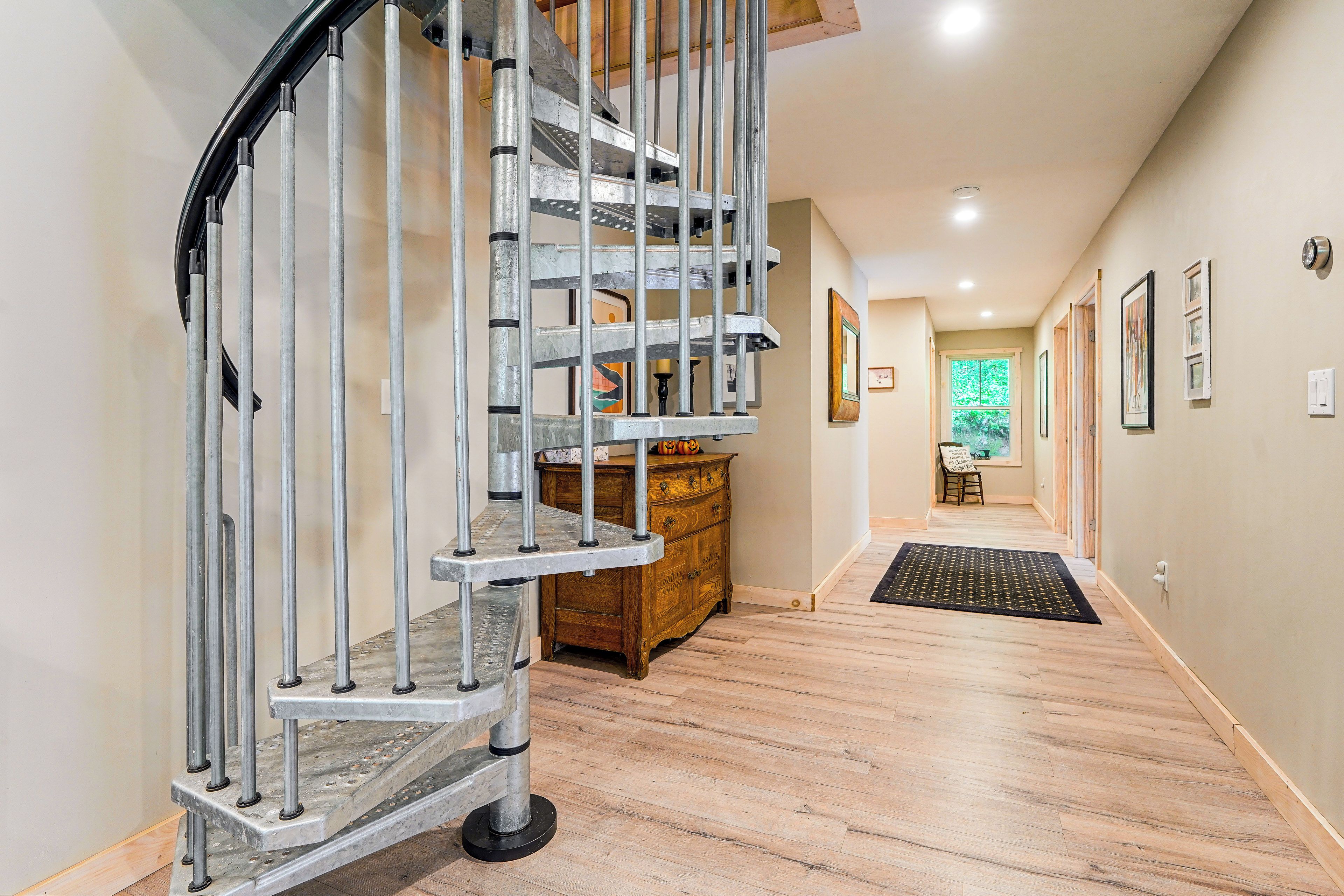 A spiral staircase with metal railings leading to a landing.