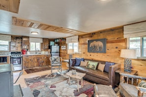 A rustic cabin interior with a kitchen, dining area, and seating space. - Historic Wondervu Cabin Near Gross Reservoir (Golden)