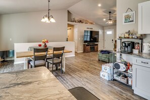 A spacious kitchen with a dining area, wooden flooring, and modern appliances. - Scenic St Claire Home: Deck + Spacious Yard (St Clair)