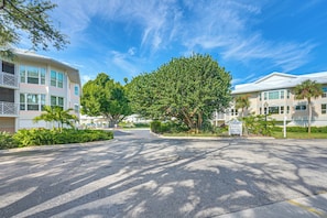 A multi-story hotel with a central courtyard, surrounded by lush greenery and palm trees. - Secluded Island Escape on Little Gasparilla Island (Placida)