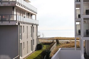 A multi-story building with balconies overlooking a body of water. - Holiday apartment with 2 bedrooms (Großenbrode)