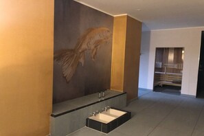 A modern bathroom with a large fish mural, a freestanding bathtub, and a walk-in shower. - Holiday apartment with 1 bedroom (Wismar)