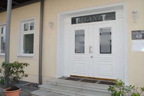 A white double door with a sign above reading 'ATLANTIC' and a small sign indicating 'Strandpromenade 45'. - Baltic Melody with panoramic Baltic Sea views (Ostseebad Binz)