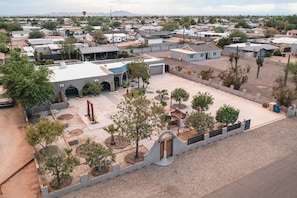 A residential area with multiple houses, a central courtyard with trees, and a large building with a flat roof. - 11327 Desert Oasis w/ Year-Round Pool (Apache Junction)