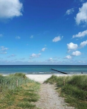 A beach path leading to the ocean with a clear sky. - Baltic Sea anchorage (Rostock)