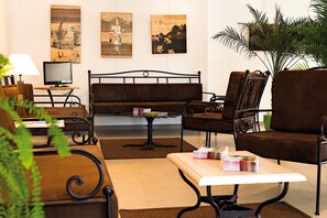 A room with a bed, two chairs, a table, a lamp, and wall art. - Provencal Family Getaway for Six (L'Isle-sur-la-Sorgue)