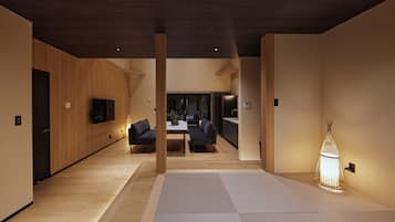 A modern interior with a wooden floor, a dining area, and a kitchen.
