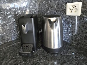 A coffee maker and a kettle on a granite countertop. - Château 15 # 2-bed apartment, Dusche, WC 2-bed apartment, Dusche, WC by Interhome (Leukerbad)