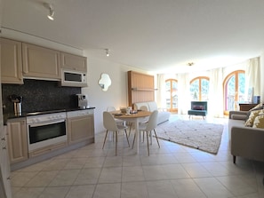 A modern kitchen with a dining area, a sofa, and a view of a mountainous landscape. - Château 15 # 2-bed apartment, Dusche, WC 2-bed apartment, Dusche, WC by Interhome (Leukerbad)