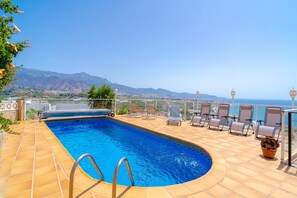 A swimming pool with a view of the sea and mountains. - Holiday Home in Nerja With Sea Views (Nerja)