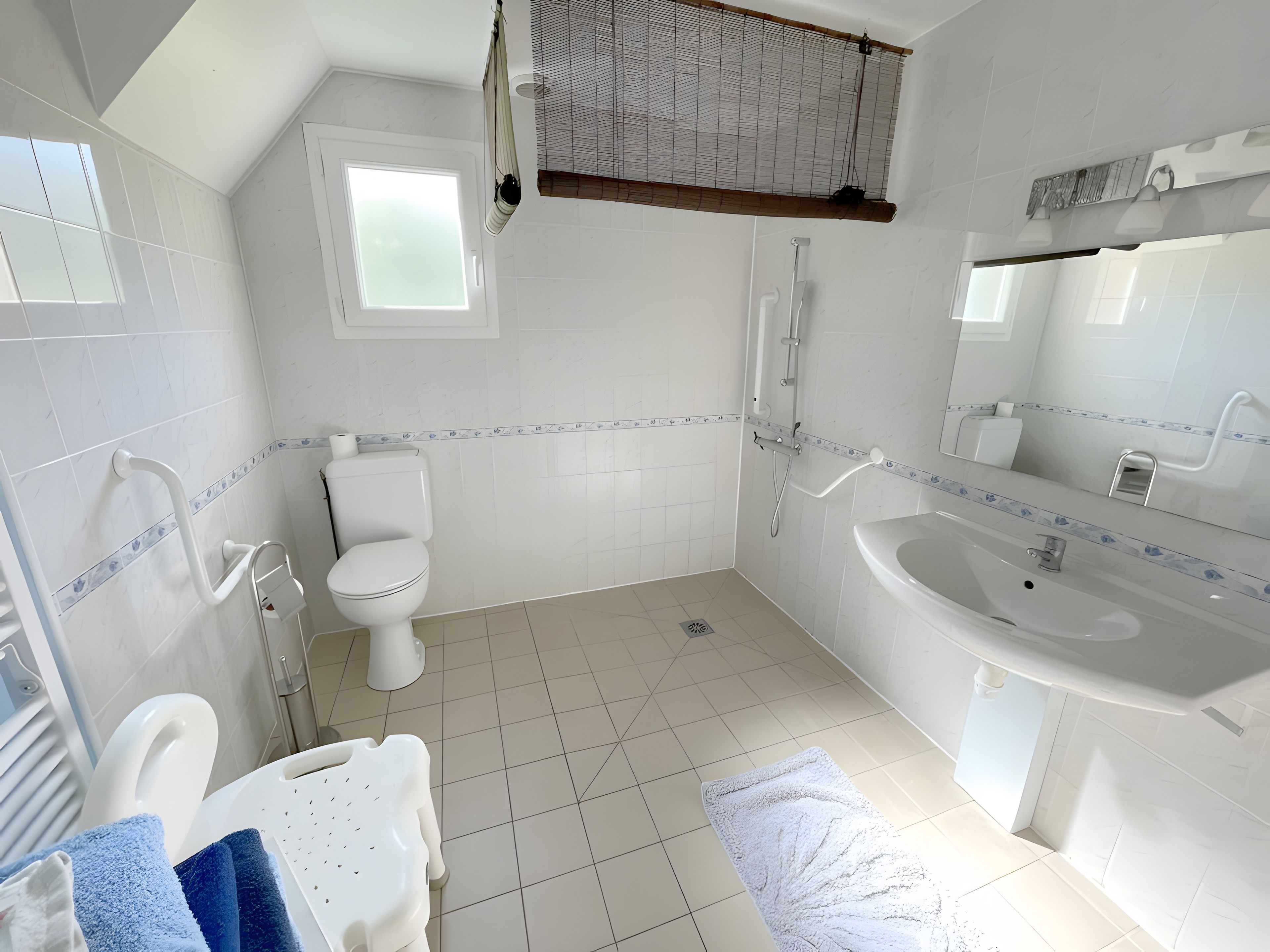 Een moderne badkamer met toilet, hygiëneschuimer en wastafel.