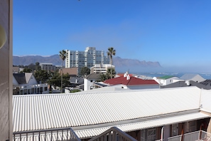 A residential area with a view of mountains and the sea. - Studio 304 @ The Majestic: One Bedroom Apartment (Cape Town)