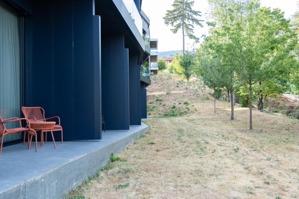 A modern building with a flat roof and a balcony area.