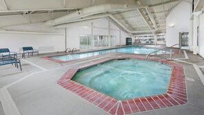An indoor swimming pool with a hot tub, benches, and a covered area with windows. - Oregon Coast 2BR Queen at WorldMark Depoe Bay – Stunning Views (Depoe Bay)