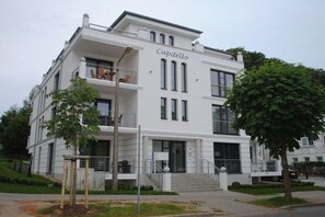 A two-story building with a balcony, a sign reading 'Capitello,' and a staircase leading to the entrance. - 8 in the Capitello Residence (Ostseebad Binz)