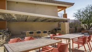An outdoor patio with a barbecue area, seating, and a pergola. - Scottsdale Studio Hotel at WorldMark – Pools, Golf & Desert Views (Scottsdale)