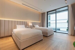 A hotel room with two beds, a large window, and a modern design. - Dere Residences - 108 (Dubai)