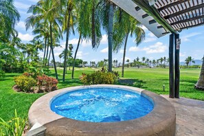 A swimming pool with a surrounding garden, palm trees, and a view of a golf course. - El Tigre De Luxe, Spacious PH Terrace & Golf View (Nuevo Vallarta)