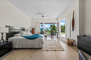 A modern bedroom with a bed, bedside tables, a desk, and a view of the outdoors. - El Tigre De Luxe, Spacious PH Terrace & Golf View (Nuevo Vallarta)