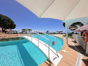 A pool area with a no entry sign, a lifebuoy, and a covered seating area. - Holiday Home With sea View, Nerja (Nerja)