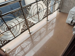 A balcony with a metal railing and a tiled floor. - Milestone Boutique Apartments (ikeja)