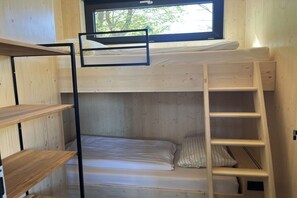 A bunk bed with a ladder and a window, wooden shelves, and a bunk bed on the upper level. - Lodges Usedom - Holiday Home 3 (Koserow)