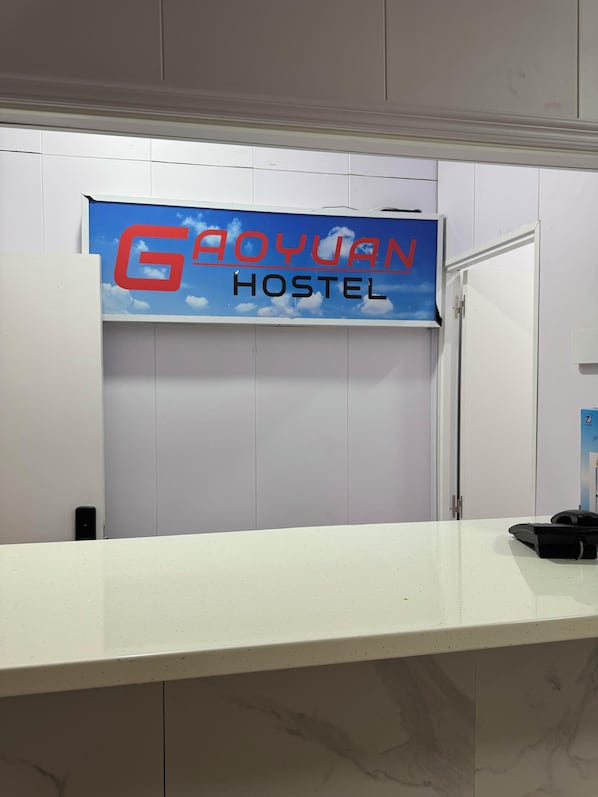 A sign for Gayo Yanu Hostel with a simple, clean design.