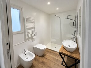 A modern bathroom with a bidet, a toilet, a shower, and two sinks. - DELIGHTFUL INDEPENDENT LOFT IN ALPI ARENA WITH FREE PRIVATE PARKING (Torino)
