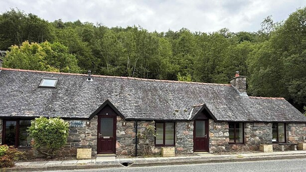 A stone cottage with a sloped roof, a wooden door, and a small window. - Stone Cottage, Glencoe, Pet friendly (Glencoe)