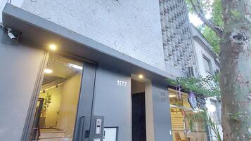 A building with a modern design, featuring a geometric facade and a visible entrance with a staircase.