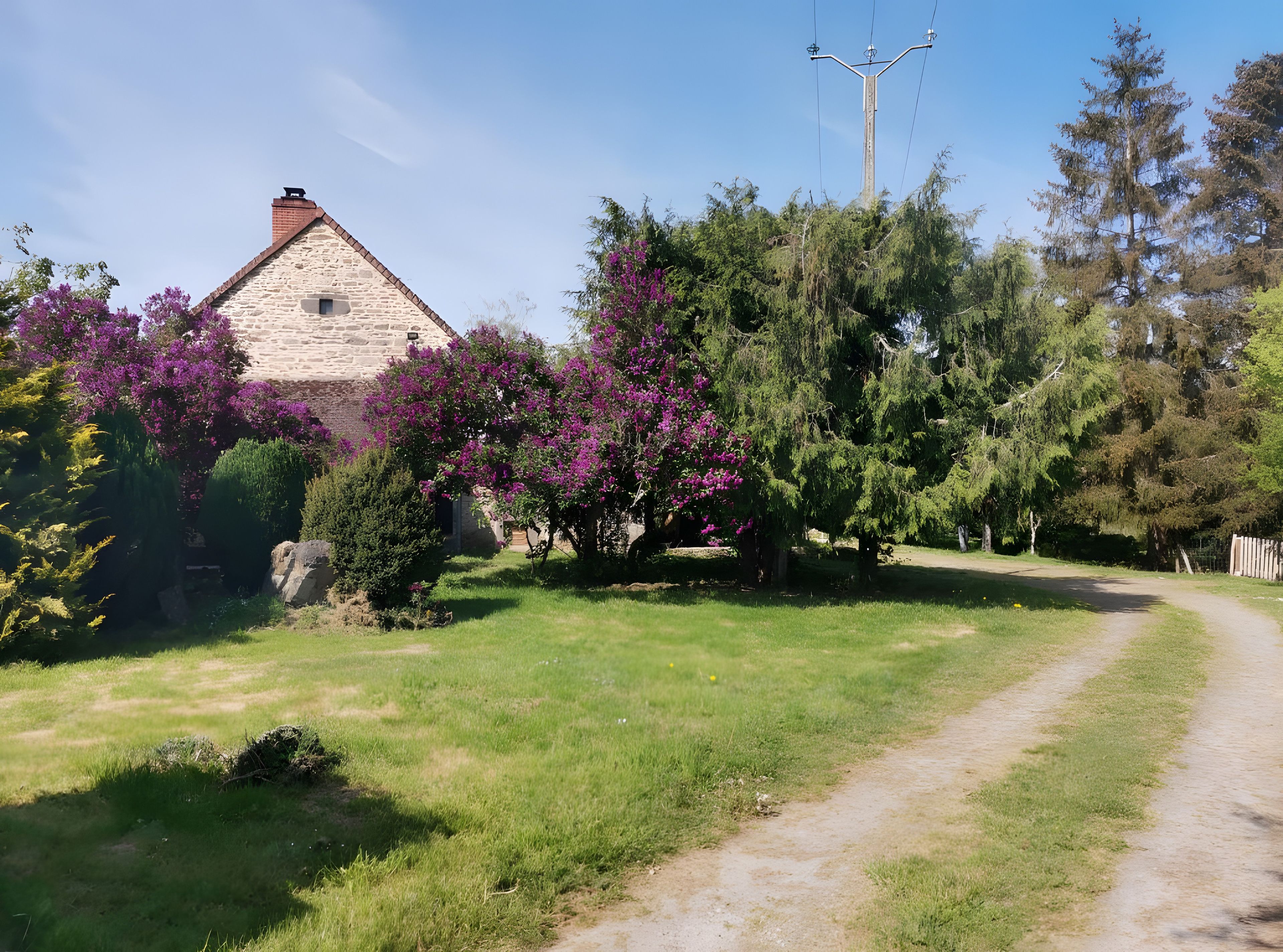 A rural landscape with a stone house, a dirt path, and lush greenery.