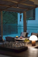 A cozy seating area with a table, chairs, and a laptop.