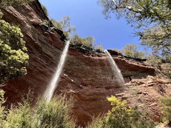 A natural rock formation with a waterfall.