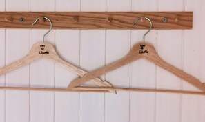 Two wooden hangers labeled 'Tiny Ubuntu' on a white wall with horizontal lines.