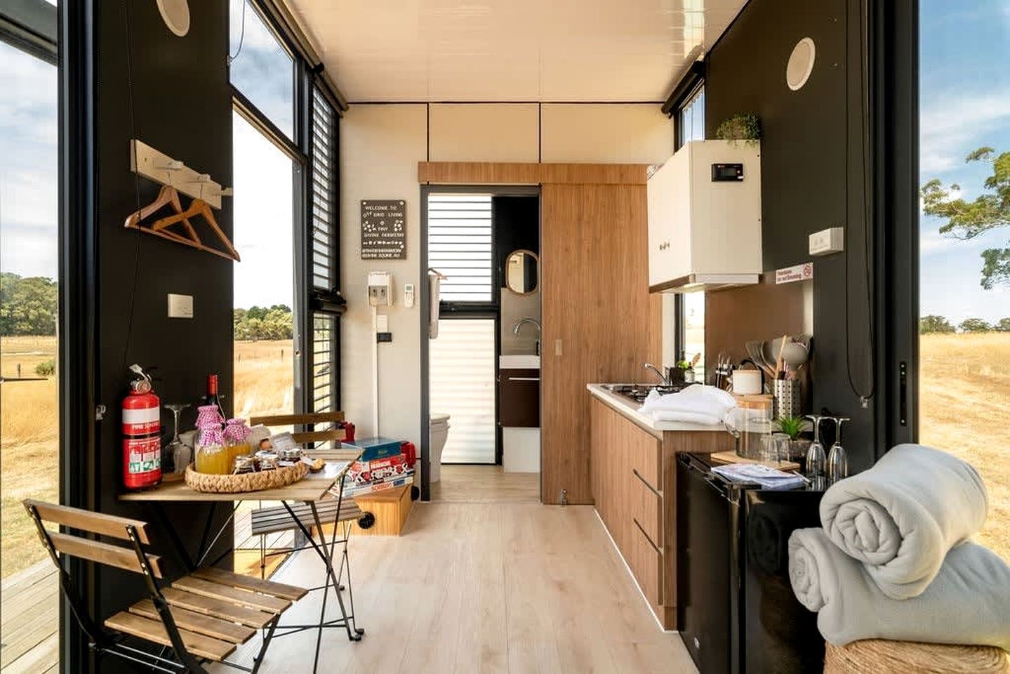 A compact kitchen with a sink, stove, and wooden cabinets.
