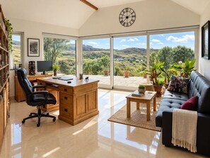 A spacious living area with a desk, office chair, and a sofa. - Atlantic Golf Retreat near Waterville (Cahersiveen)