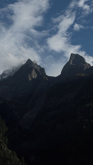 A mountainous landscape with two prominent peaks and a valley.