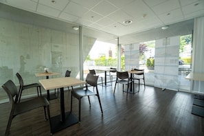 A modern interior with glass partitions, wooden flooring, and contemporary furniture. - Hine Adon Apart Bern Airport (Belp)