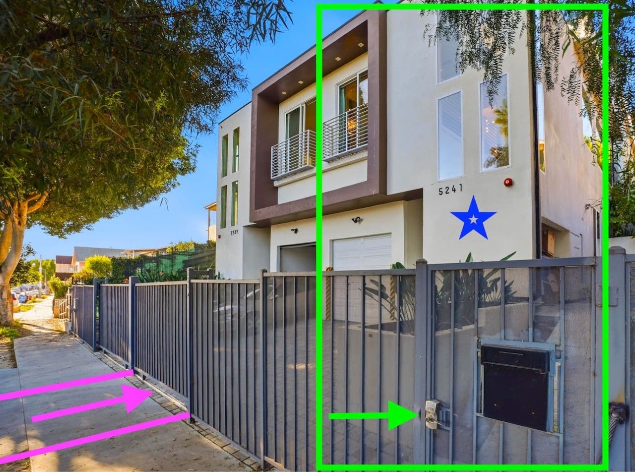 A modern two-story building with a gated entrance, a blue star symbol, and a garage door.