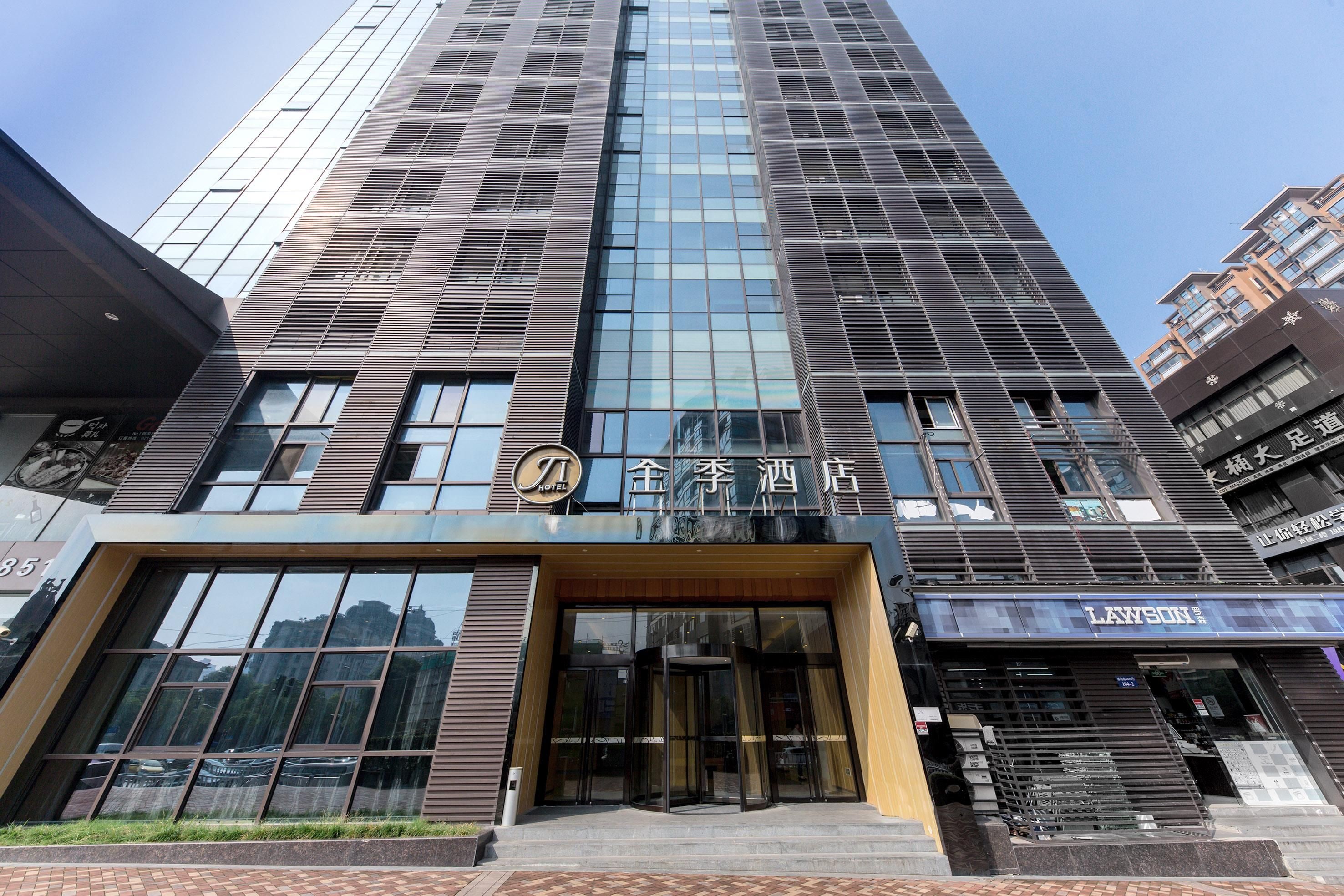 A modern hotel with a prominent entrance, large windows, and a visible sign for Lawson.