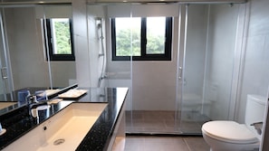 A modern bathroom with a black countertop sink, a glass shower enclosure, and a toilet. - Chiilih Hotel- Su ao (Suao)